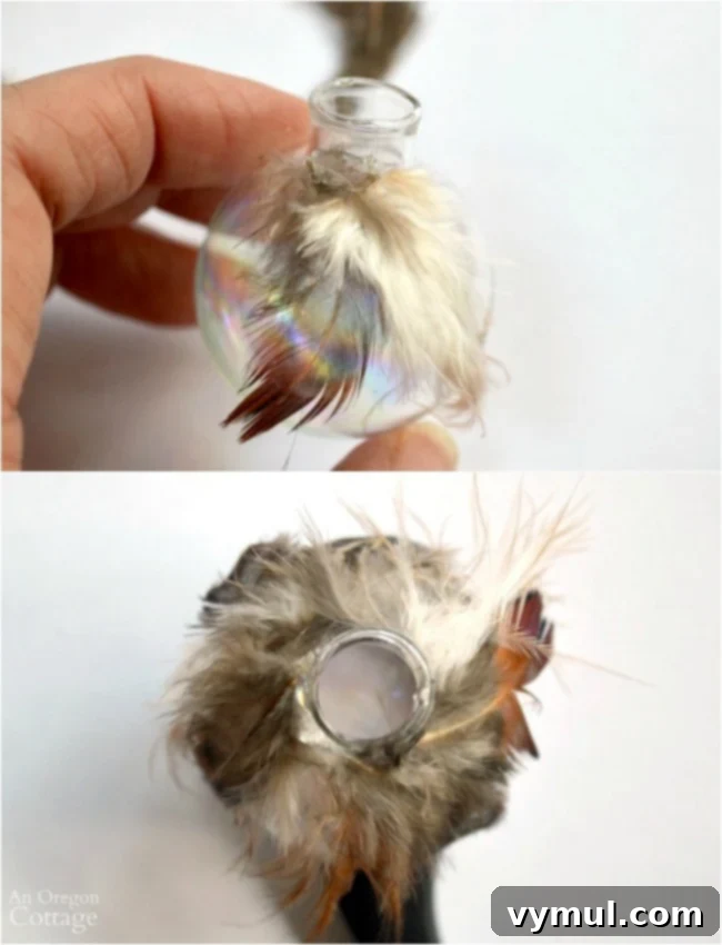 Effortless Feather & Glass Christmas Ornament Craft 6 Applying feathers to a glass ball for Christmas ornament DIY using hot glue.