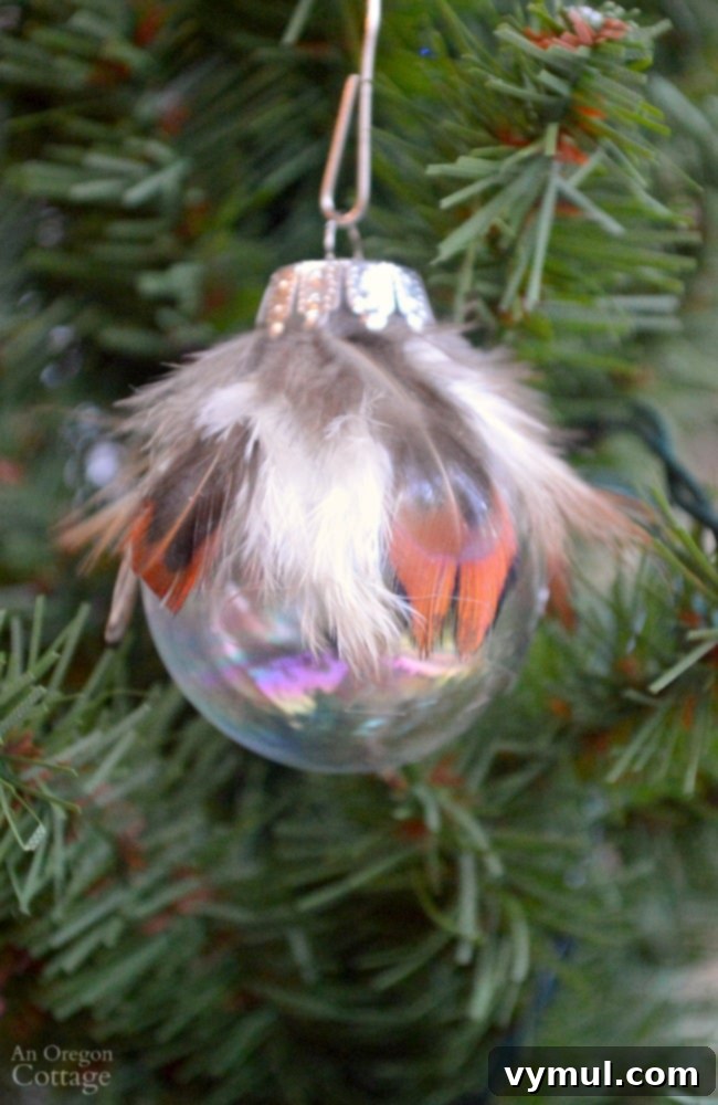 Effortless Feather & Glass Christmas Ornament Craft 7 Completed simple feather and glass ball Christmas ornament DIY, showcasing the final product.