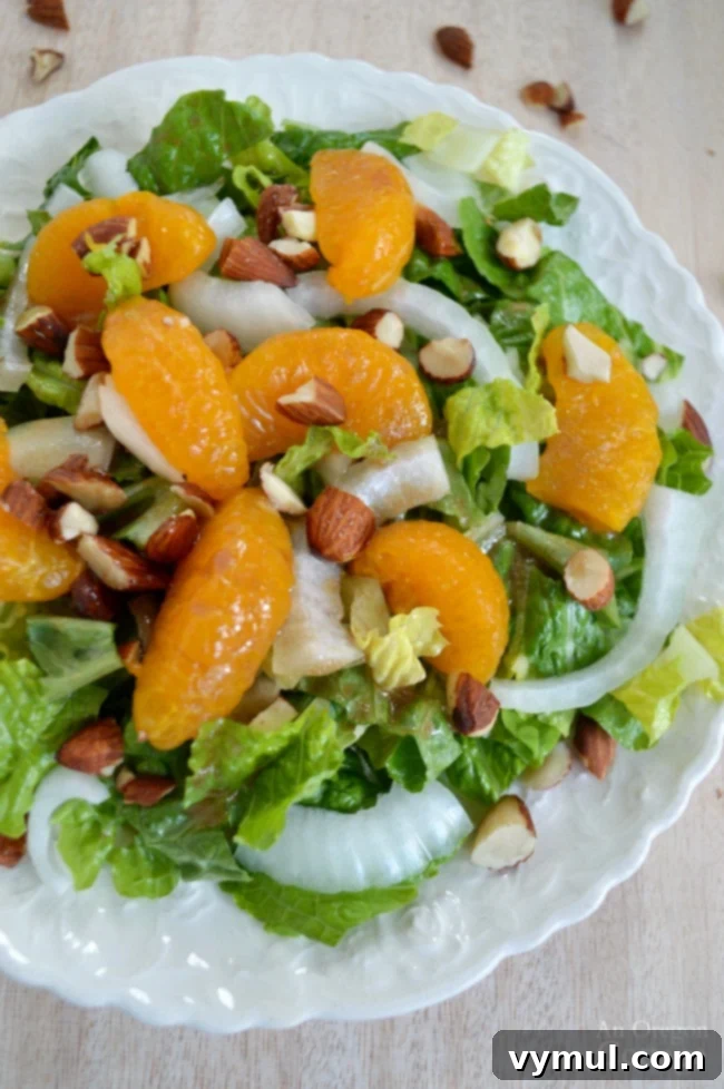 Zesty Orange Almond Salad with Balsamic Vinaigrette 2 Orange Almond Salad - top greens with sweet onions, mandarin oranges, crunchy almonds and drizzle it all with an orange balsamic dressing for a quick and refreshing dinner salad.