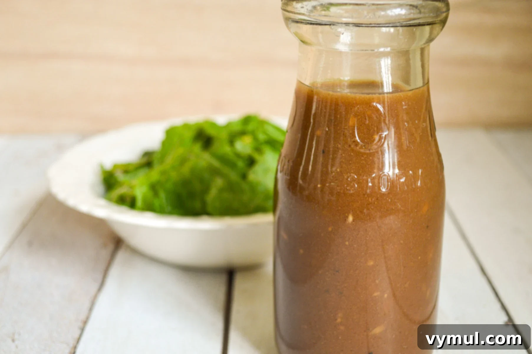 One Easy Vinaigrette Recipe Infinite Flavor Options 11 Balsamic dressing poured over a fresh bowl of salad