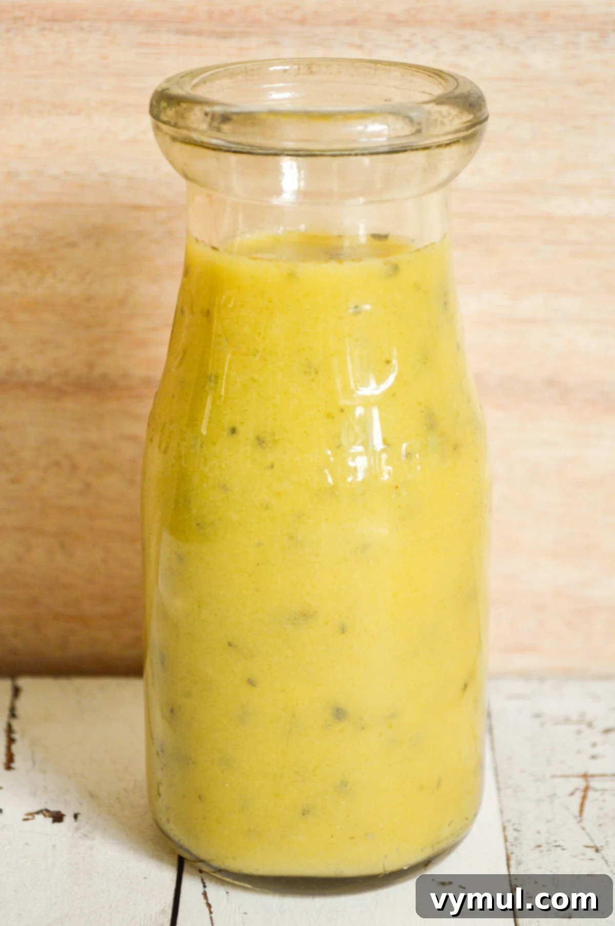 One Easy Vinaigrette Recipe Infinite Flavor Options 8 Lemon herb salad dressing in a glass bottle, ready to pour