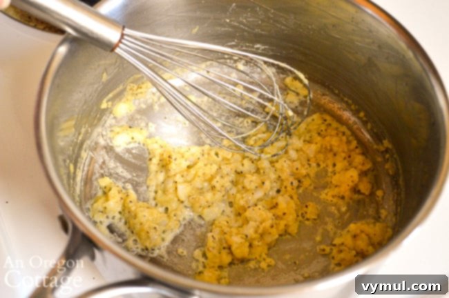 Velvety Broccoli Cauliflower Parmesan Bake 5 Melted butter with finely chopped onions and garlic sizzling in a saucepan for the white sauce base