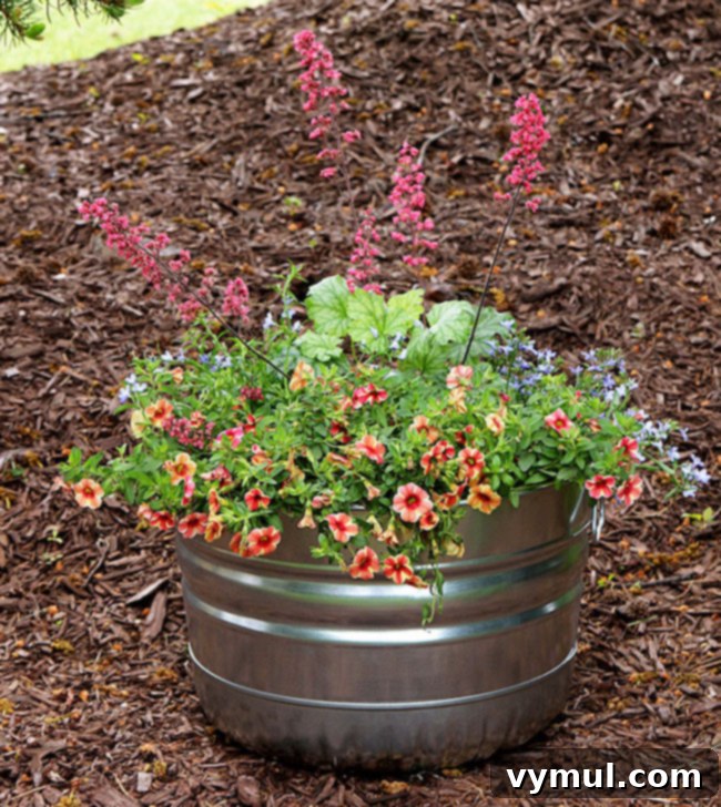 Sun-Kissed Planters: Vibrant Color Ideas 18 Metal container garden with perennial coral bells, annual lobelia and calibrachoa from House of Hawthornes