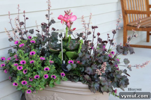 Sun-Kissed Planters: Vibrant Color Ideas 6 Summer porch planter with pink canna, pink and green supertunia, and coral bells via House of Hawthornes