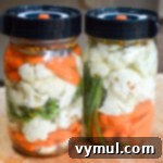 two jars of fermented vegetables with lids