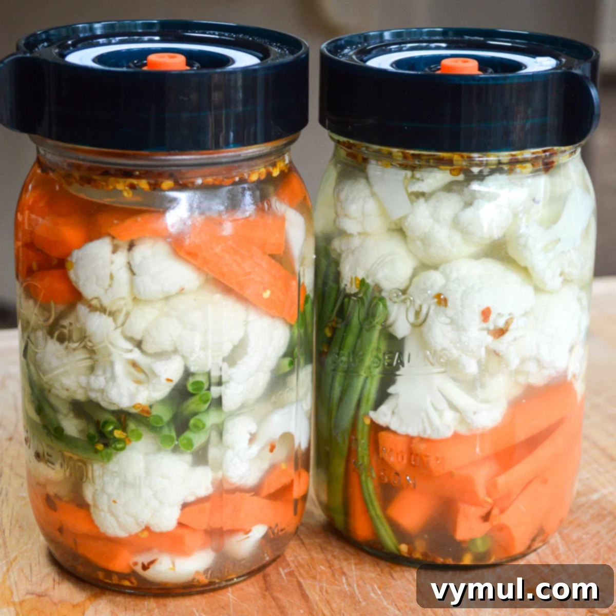 two jars of fermented vegetables with lids