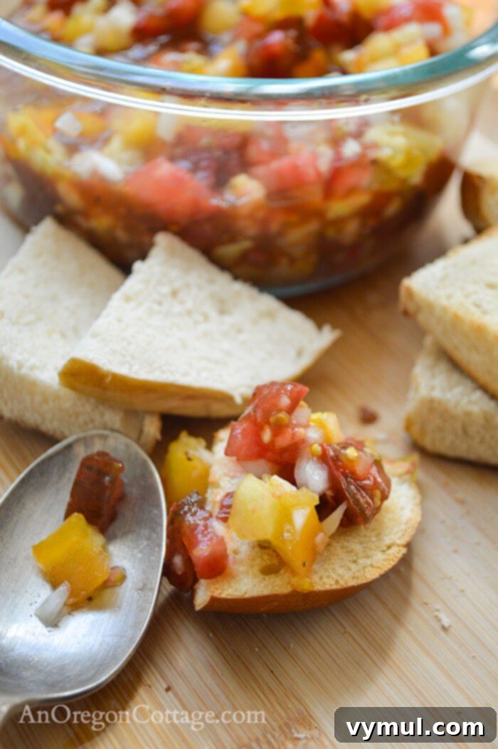 fresh tomato bruschetta on toasted bread with a spoon in a bowl