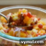 fresh tomato bruschetta topping on a spoon, ready to be served