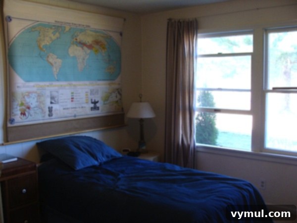 Series Three: Reimagining Our Restful Retreats 3 Son's bedroom after remodeling, painted white with vintage school map - An Oregon Cottage