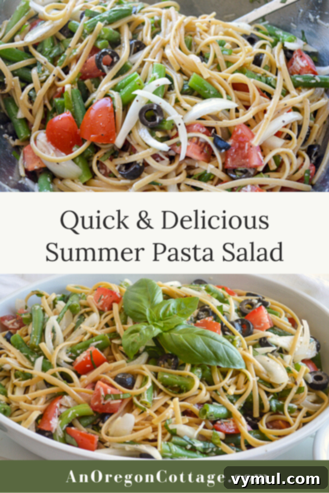 Beautifully presented summer pasta salad with fettuccine, tomatoes, green beans, and parmesan