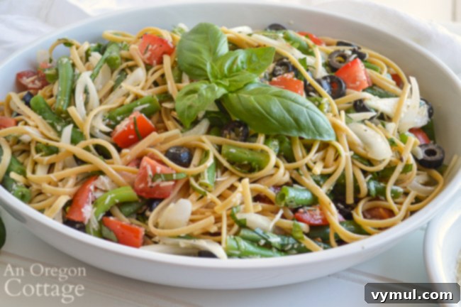 Delicious summer pasta salad served in a white bowl, ready to enjoy