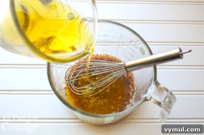 Whisking homemade Italian vinaigrette dressing for summer pasta salad