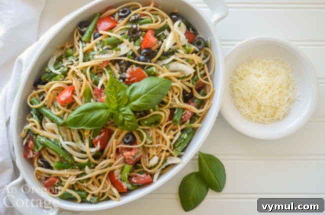 Close-up of the delicious summer pasta salad, garnished with basil and parmesan