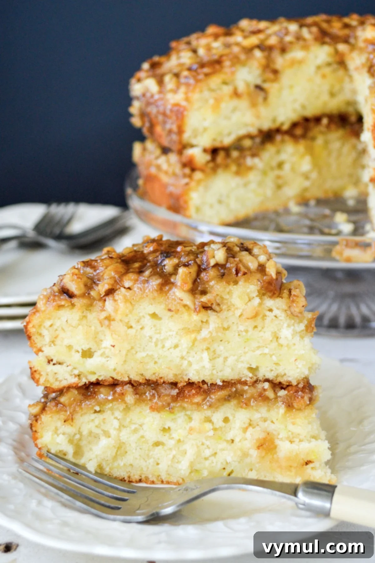 Decadent Moist Zucchini Cake with Toasted Caramel Nut Frosting 2 cut slice of zucchini cake on white plate