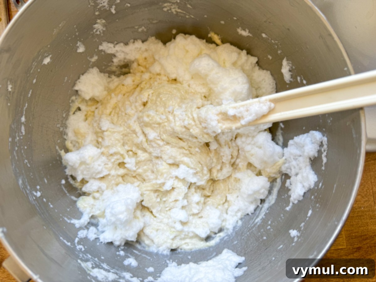 Decadent Moist Zucchini Cake with Toasted Caramel Nut Frosting 11 folding egg whites into cake batter