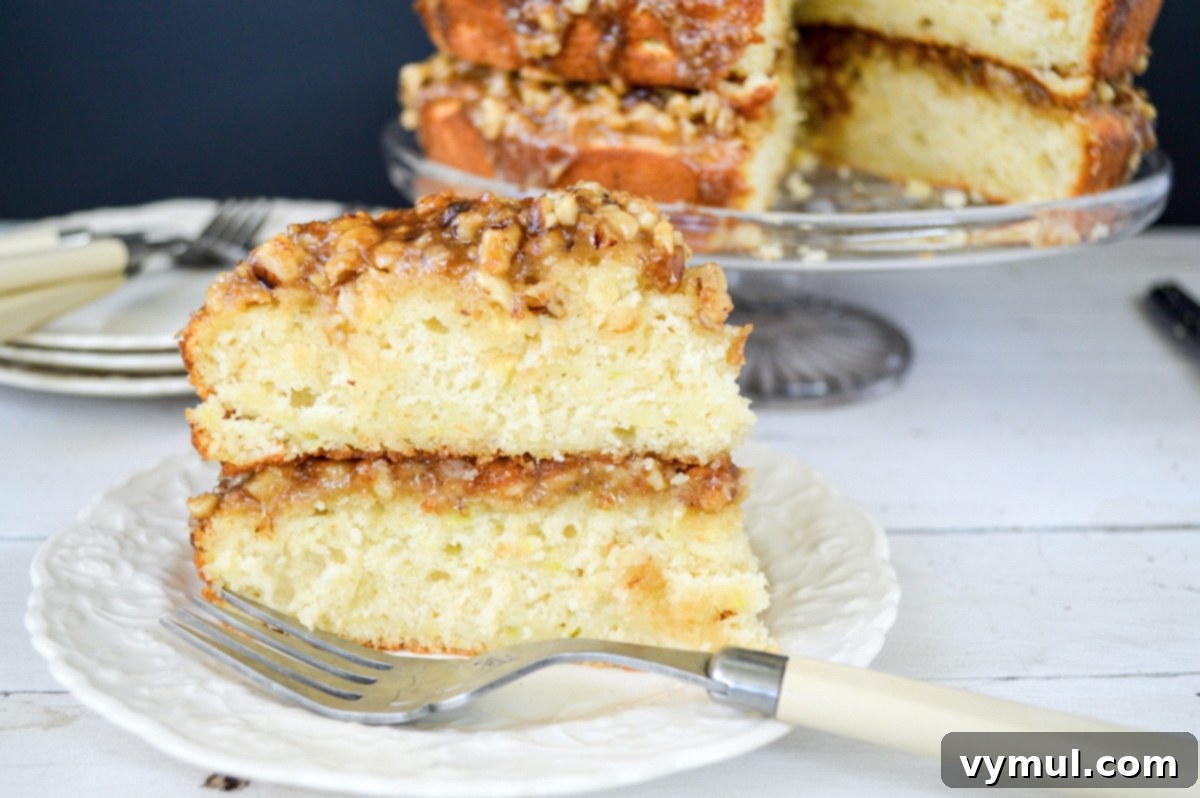 Decadent Moist Zucchini Cake with Toasted Caramel Nut Frosting 14 slice of zucchini cake on a white plate with fork