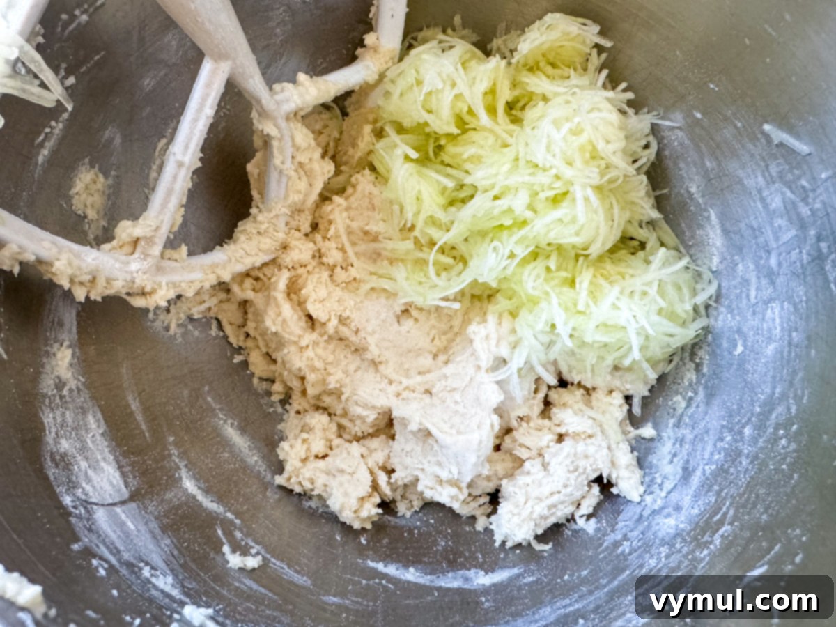 Decadent Moist Zucchini Cake with Toasted Caramel Nut Frosting 10 mixing zucchini into cake ingredients