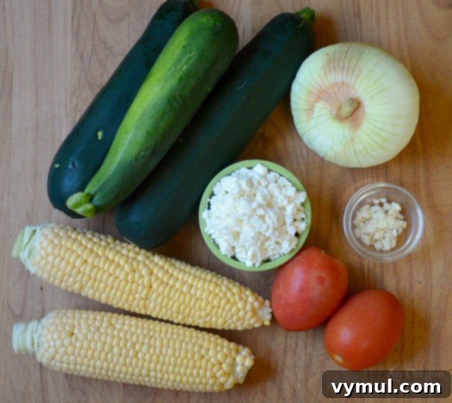 Sunny Zucchini, Corn, and Tomato Skillet with Feta 4 Zucchini Corn and Tomato Saute ingredients laid out on a cutting board, ready for prep