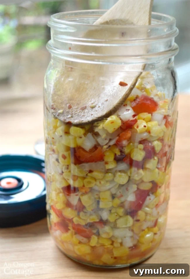 Easy 5-Minute Fermented Corn Relish Magic 6 Easy Fermented Corn Relish ingredients being pressed down into a jar