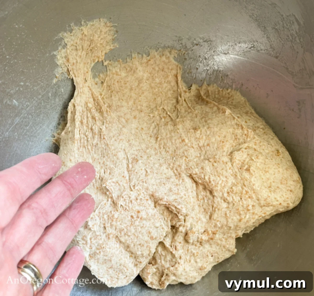 Simple Wholesome Homemade Pita 7 tacky kneaded pita dough on finger and sticking to bottom of bowl