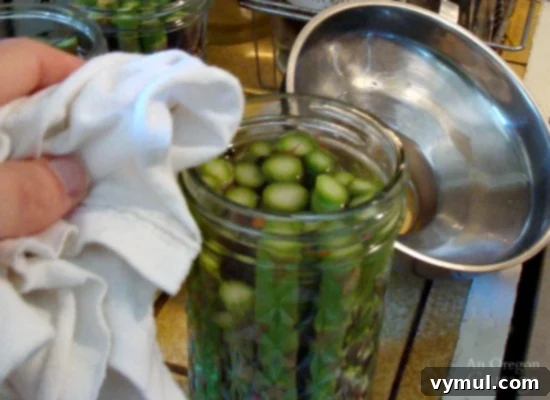 Mastering Pickled Asparagus A Simple Canning Tutorial 12 Pickling and Canning Asparagus_10-wiping rim