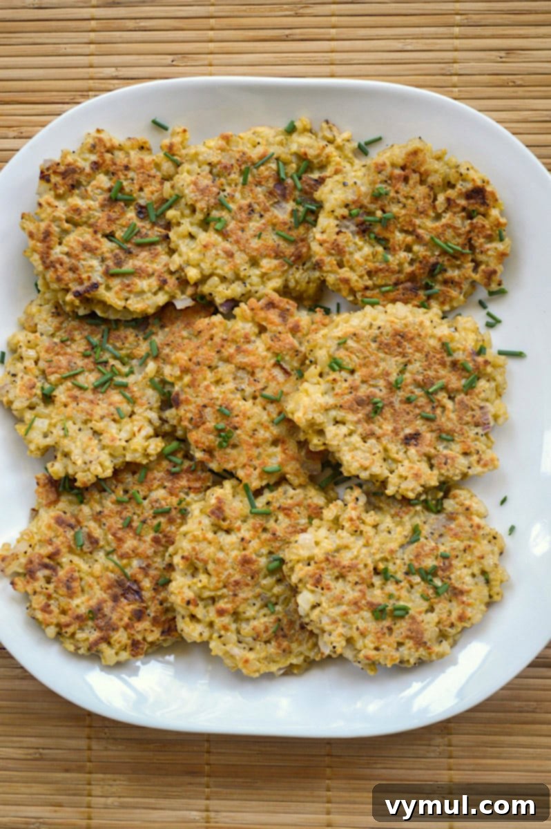 Savory Parmesan Rice Cakes Made Easy 5 rice patties on white platter from above
