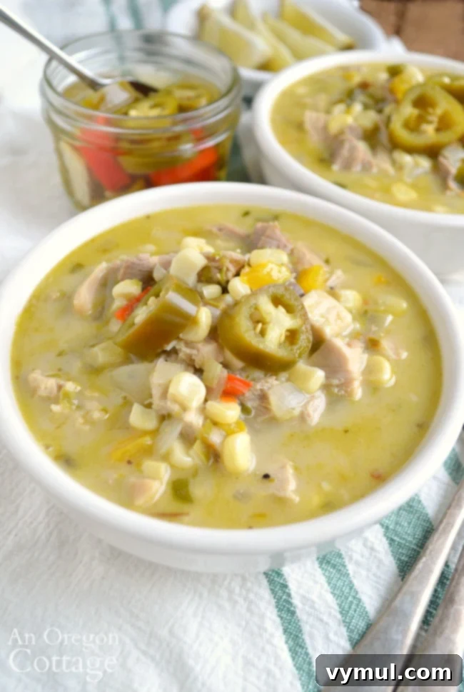 A close-up shot of a bowl of creamy Mexican chicken corn soup, showcasing its rich texture and colorful ingredients like corn and chicken, perfect for a quick and healthy meal.