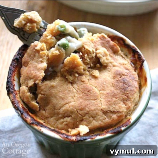 A forkful of Cheesy Crust Ham Pie, showing the flaky crust and savory filling.