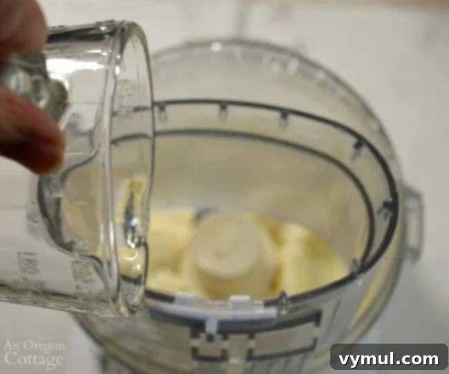 Adding oil in a slow stream to food processor for homemade mayonnaise