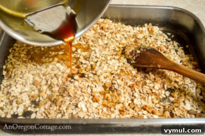 Speedy Pantry Granola 5 pouring sugar mixture on oat mix