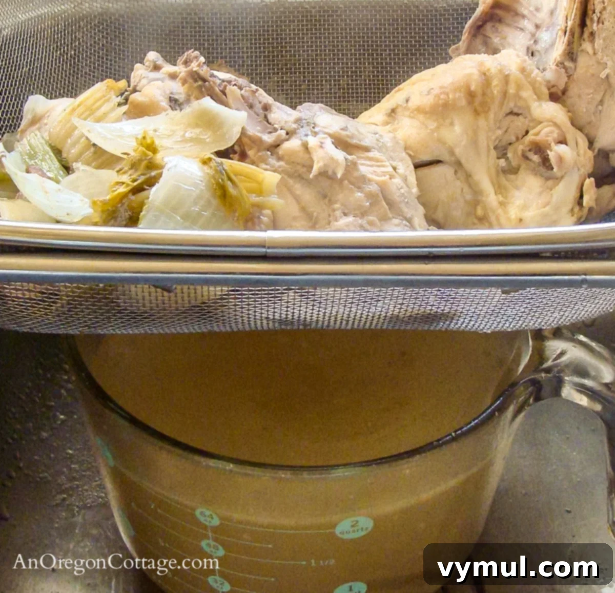 straining chicken stock bone broth