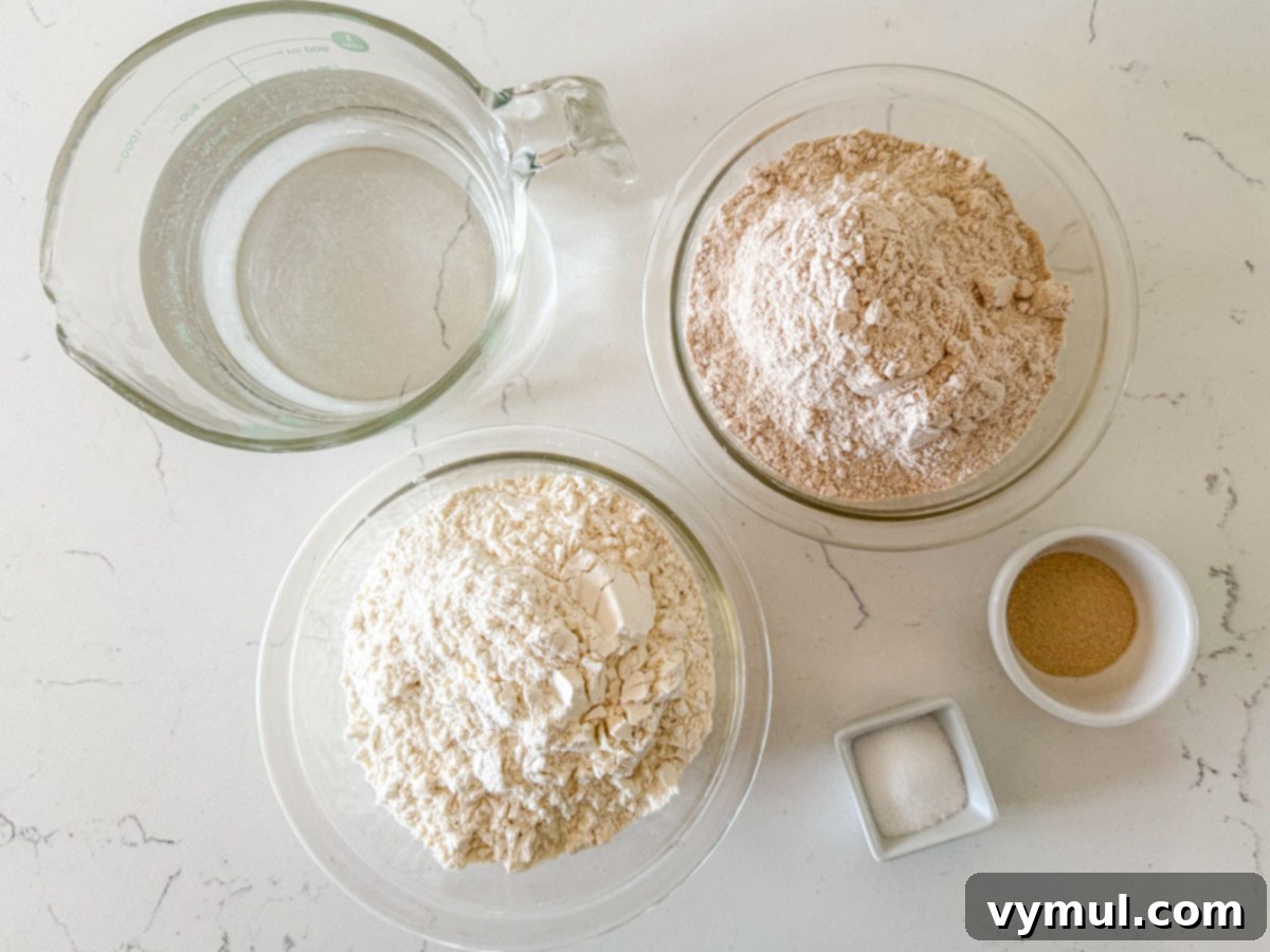 Foolproof Dutch Oven Whole Wheat Artisan Bread 4 Basic artisan bread recipe ingredients laid out: flour, water, yeast, and salt.