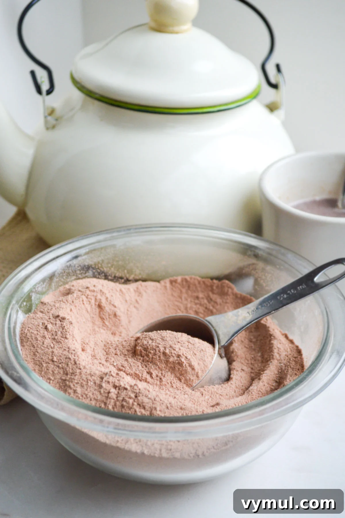 bowl of homemade hot cocoa mix with measuring scoop