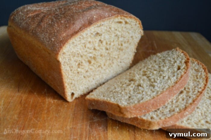 Close-up of perfectly sliced 100% whole wheat sandwich bread, highlighting its soft, even crumb and golden crust.