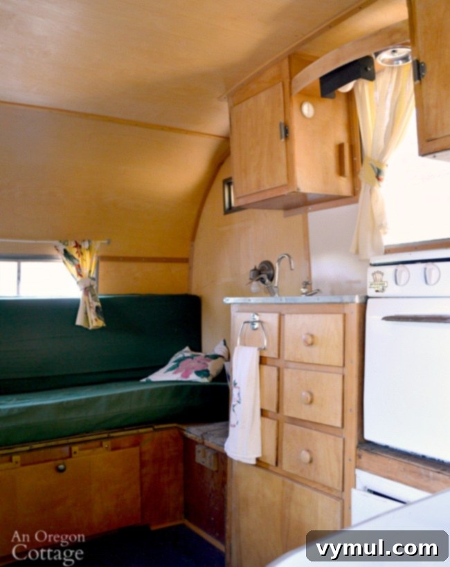Ep. 5: Camper Quirks, Culinary Conquests, and Canine Catastrophes 5 The refurbished kitchen and bench area of the Dalton vintage trailer, highlighting modern comfort within a retro setting.