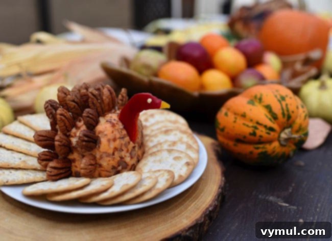 Thanksgiving Crunch Time: 23 Last-Minute Ideas for Doing, Dining, & Discovering 11 Turkey-cheese-ball-recipe-for-Thanksgiving, a festive turkey-shaped cheese ball, adorned with crackers and pretzels to resemble feathers, a fun and delicious appetizer for Thanksgiving.