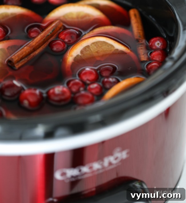 Thanksgiving Crunch Time: 23 Last-Minute Ideas for Doing, Dining, & Discovering 10 crock-pot-sangria, a warm, inviting crock-pot sangria, garnished with apple slices and cinnamon sticks, perfect for a cozy Thanksgiving gathering.