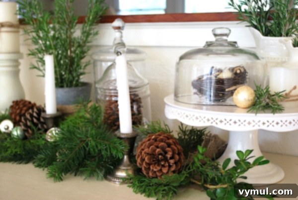 Sideboard Christmas Vignette: A charming holiday display on a sideboard, featuring white, silver, and burlap elements creating a festive scene.