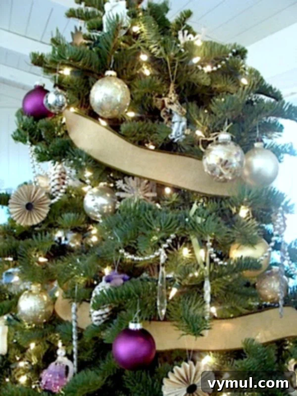 2011 Christmas Tree: A close-up view of a festive Christmas tree adorned with unique ornaments crafted from vintage book pages and sheet music, creating a nostalgic and literary theme.