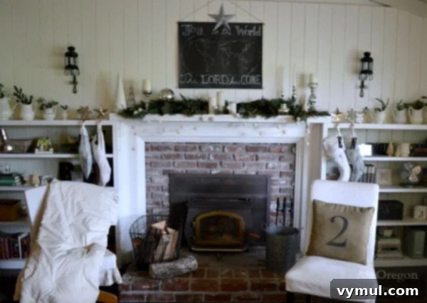 Cottage Christmas Mantel Wall: A festive display featuring a white chalkboard with holiday greetings, complemented by mercury glass accents and lush greenery.