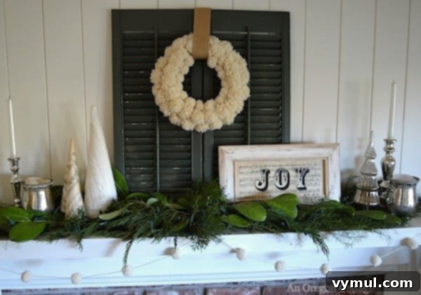 White and Green Christmas Mantel: A serene and natural holiday mantelpiece adorned with fresh greenery, white candles, and minimalist decorations.
