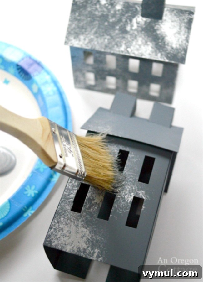 Create a Faux Galvanized Finish Step-by-Step Guide 5 Applying a gray base coat to metal houses for a faux galvanized finish.