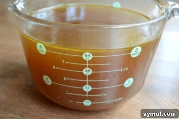 Easy Homemade Bone Broth Slow Cooker and Instant Pot 7 Slow Cooker Chicken broth in measuring cup