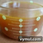 Easy Homemade Bone Broth Slow Cooker and Instant Pot 8 Slow Cooker Chicken broth in measuring cup