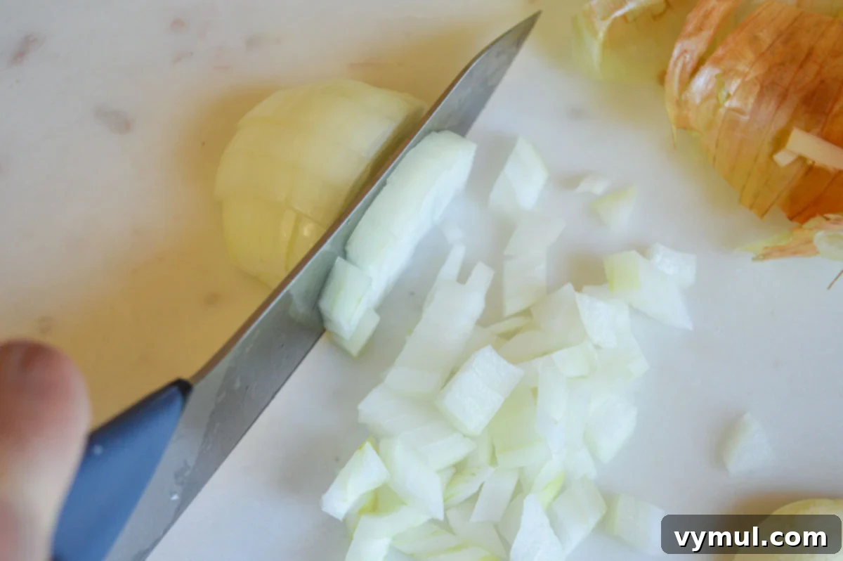 Easy 30 Minute Creamy Shrimp Pasta with Green Beans 6 dicing half an onion