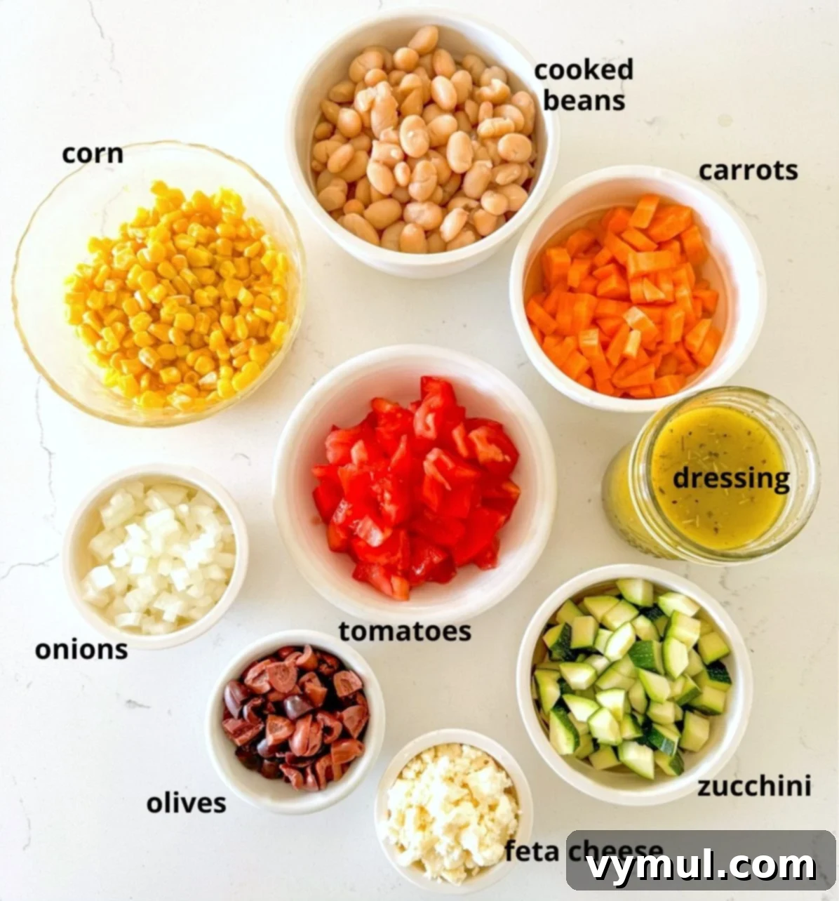 Fast Flexible Chopped Salad 3 Various chopped salad ingredients laid out on a white kitchen counter