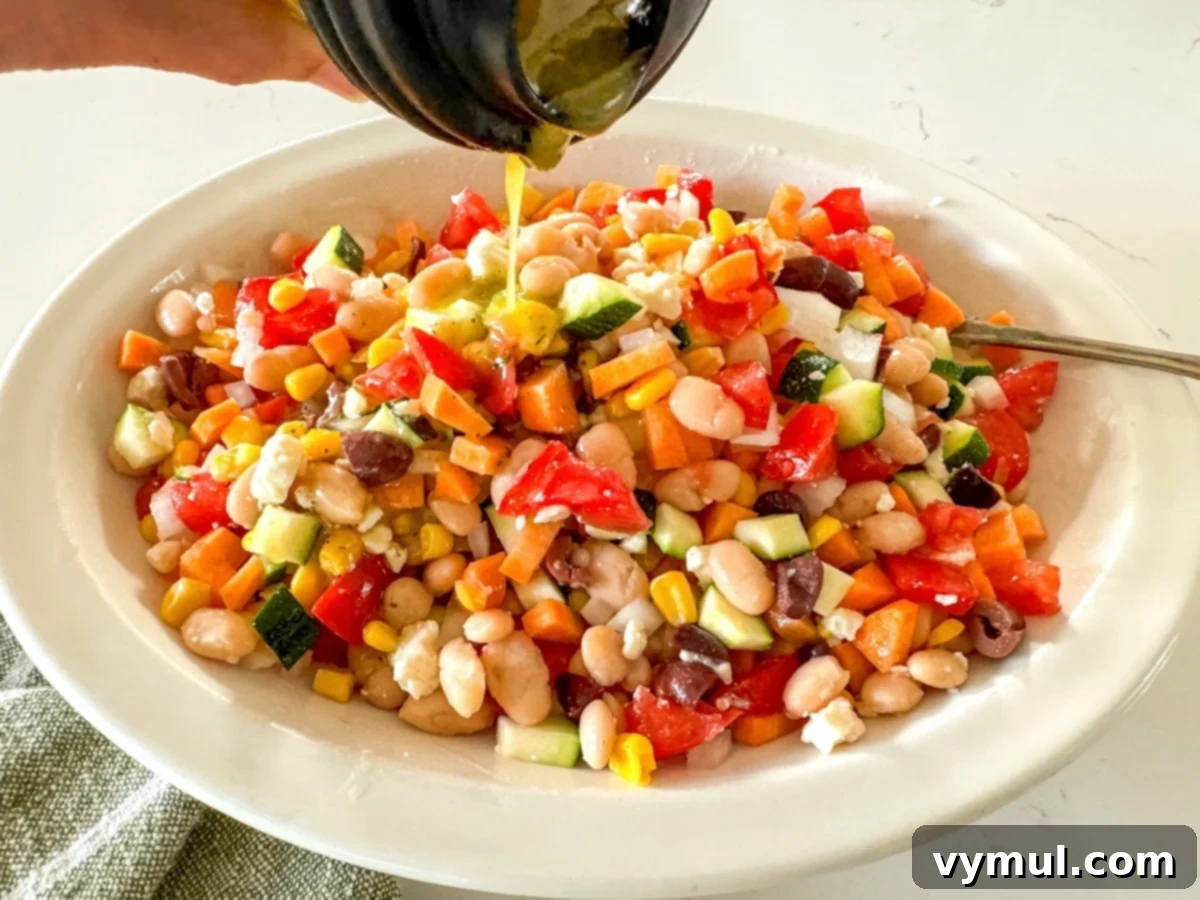 Fast Flexible Chopped Salad 6 Pouring salad dressing over chopped salad ingredients in a white bowl
