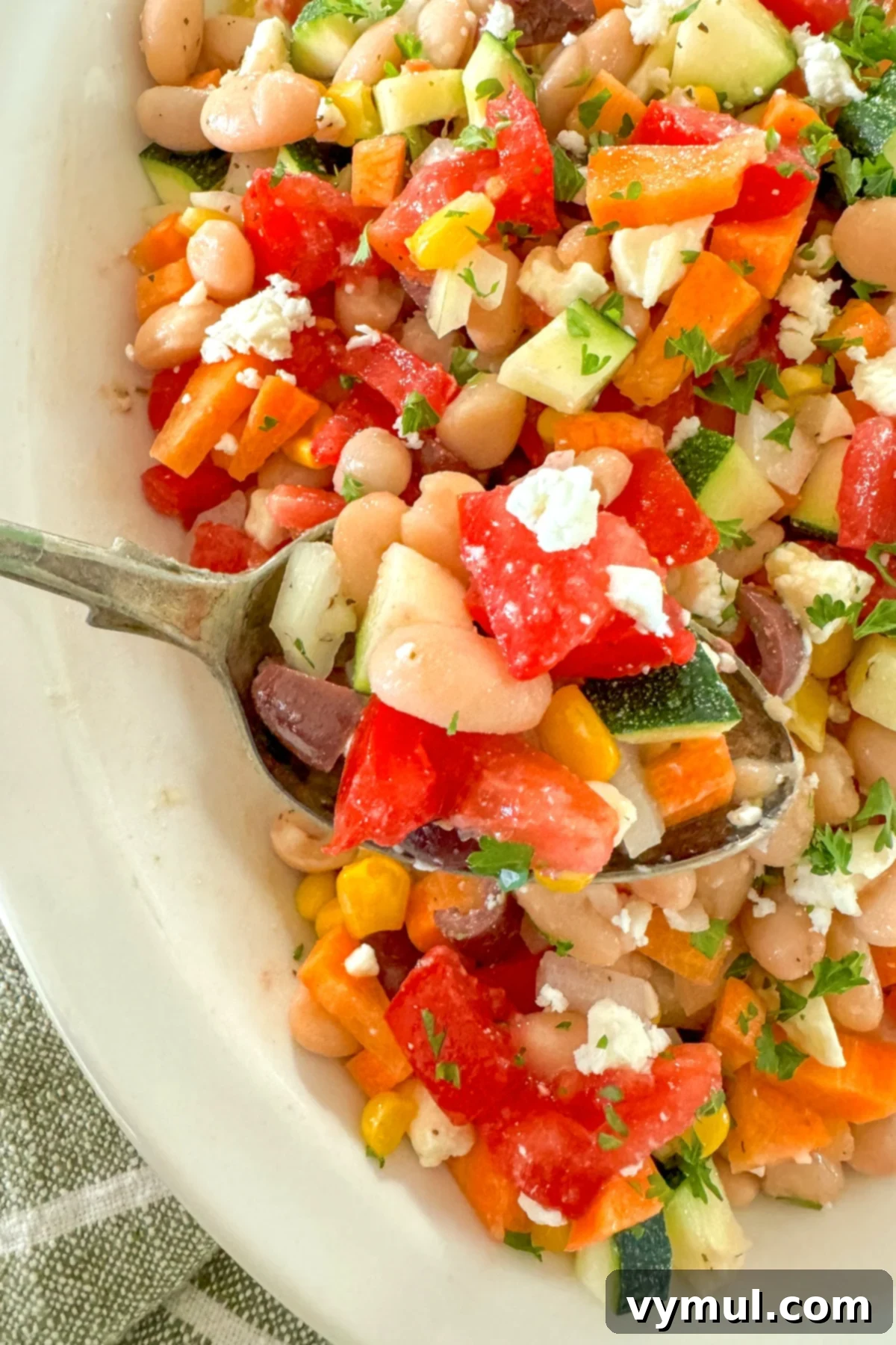 Fast Flexible Chopped Salad 8 A serving of chopped salad being spooned from a white bowl