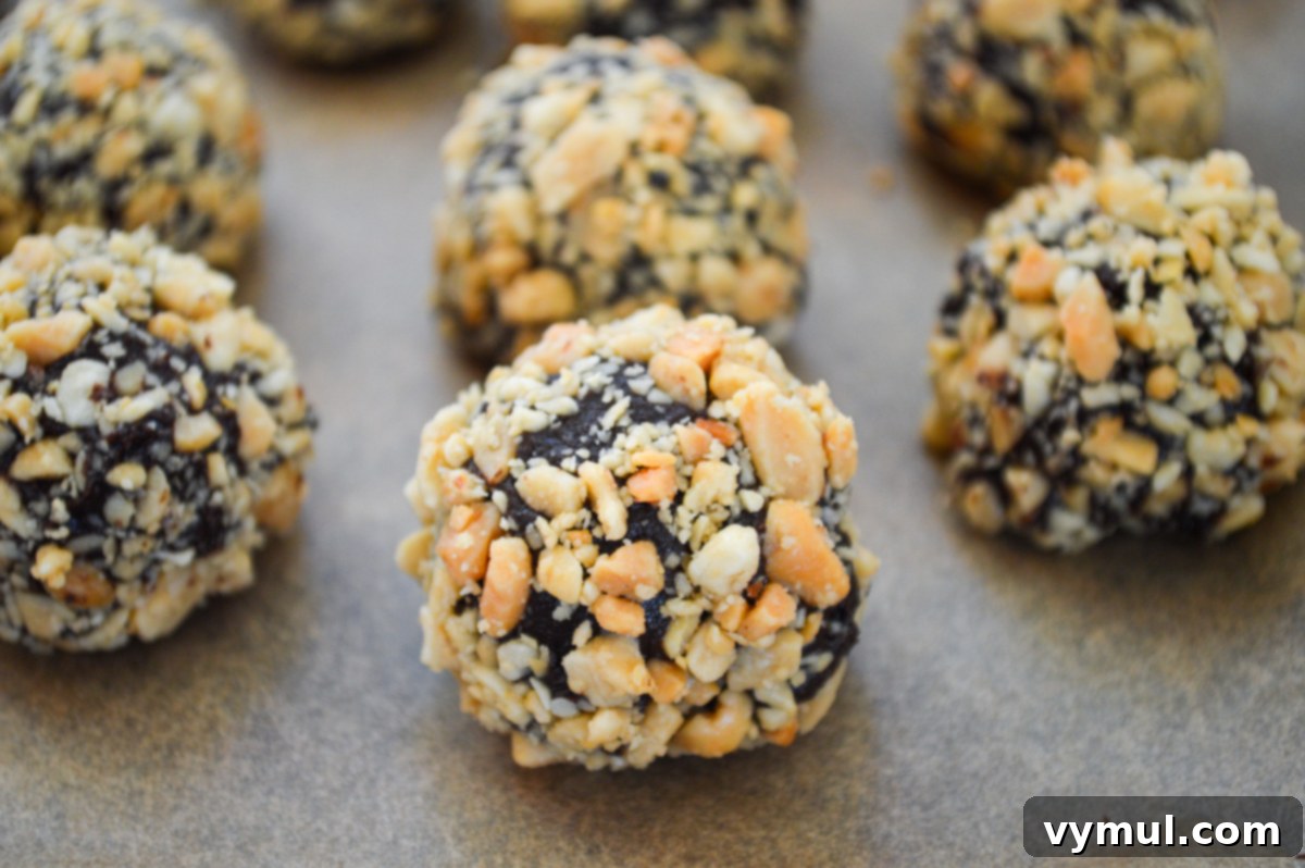 16 Wholesome & Easy Desserts: Six Ingredients or Fewer 4 peanut butter truffles rolled in peanuts on parchement