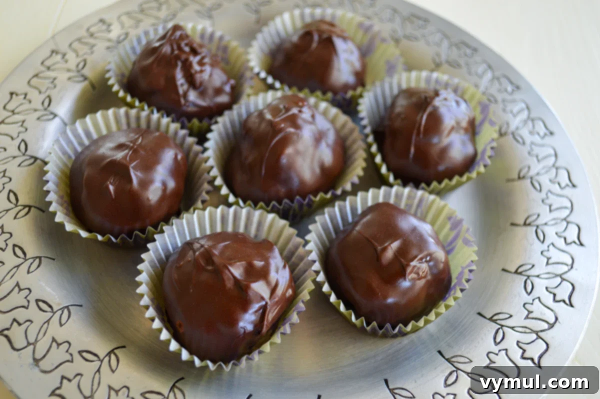 16 Wholesome & Easy Desserts: Six Ingredients or Fewer 8 chocolate covered crispy peanut butter balls on silver plate